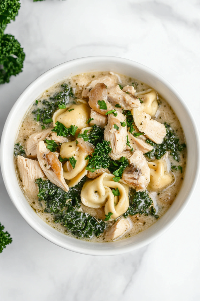 chicken-and-kale-tortellini-soup-in-a-white-bowl