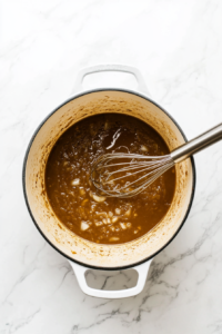 pouring-in-vegetable-broth in the sauted onions