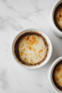 This image shows a bowl of soup served with a slice of chaffle or low-carb bread on top, ready to enjoy.