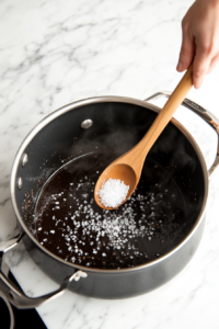 This image shows a soup pot being seasoned with salt and pepper, adjusting the taste to perfection.