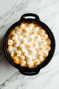 melted and slightly puffy -marshmallows-on-cooked-crockpot-sweet-potatoes-casserole ready to be served