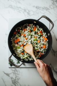 onions-celery-carrots-and-garlic-being-sauted-in-a-pan in the butter