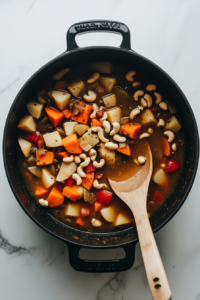 This image shows broccoli florets, diced potatoes, and seasonings being added to a pot, combining key ingredients for the vegan broccoli cheese soup.