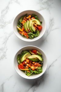 This image shows ripe avocado slices being placed on top of the kani salad, adding creaminess and a rich texture to the dish.