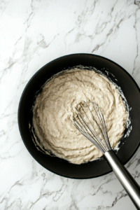 adding-vegetable-broth-and-non-dairy-milk-to-the-roux-for-vegan-pasta-sauce