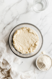 This image shows the dough being adjusted for the right consistency, ensuring it is firm yet pliable for the perfect Vegan Treacle Tart crust.