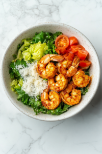 this image shows perfectly plated Keto Cajun Shrimp Caesar Salad, topped with seared Cajun shrimp, creamy Caesar dressing, and a garnish of Parmesan cheese for a hearty, flavorful meal.