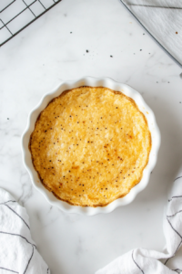 This image shows a pie crust turning a golden brown as it bakes in the oven, ready to be filled with rich brownie batter.