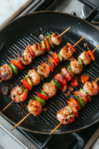 This image showcases perfectly grilled shrimp skewers, with golden shrimp and charred vegetables, ready to be served as a keto-friendly dish.