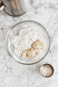 mixing bowl with creamed butter and sugars, now having an egg, an egg yolk, and vanilla extract added for extra richness and flavor in the salted caramel cookie dough.