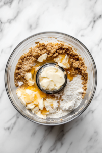 This image shows the process of combining the ingredients for the Vegan Treacle Tart pastry dough, ensuring a smooth and flaky base for the tart.