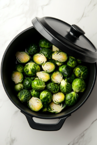 this image shows Brussels sprouts being cooked until tender, forming a key ingredient in the creamy garlic sauce for the pasta dish.