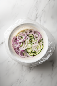 covering-cucumber-salad-with-plastic-wrap-and-refrigerating