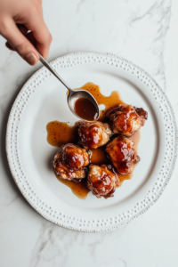 This image shows a rich honey garlic sauce being poured over chicken thighs arranged on a serving platter, adding extra flavor and shine.