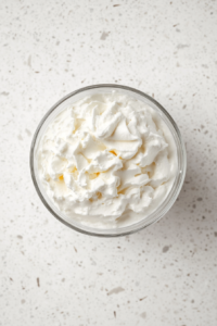 This image shows the smooth and fluffy texture of the final vegan whipped cream, ready to be served and enjoyed.