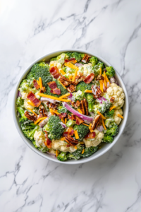 this image shows Crispy bacon pieces being folded into the dressed salad, completing the dish.