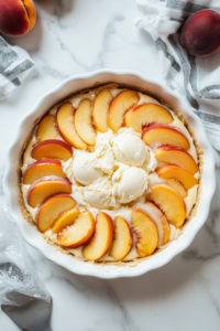 This image shows the fully assembled cream pie being placed in the freezer to firm up, ensuring the layers of ice cream and peaches are perfectly set before serving