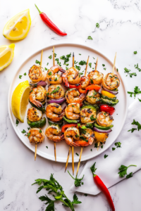 This image showcases perfectly grilled shrimp skewers, with golden shrimp and charred vegetables, ready to be served as a keto-friendly dish.