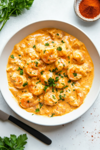 This image shows the finished Bang Bang shrimp pasta garnished with fresh parsley, adding a touch of color and freshness to the creamy dish.