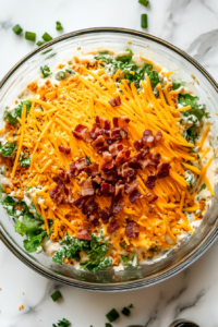 This image shows the low-carb pea salad garnished with extra shredded cheese and crispy bacon pieces, adding a decorative and tasty finishing touch.