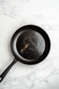 This image shows the Cajun spice mixture sizzling in a skillet as it warms up, releasing its rich aroma before adding the shrimp.