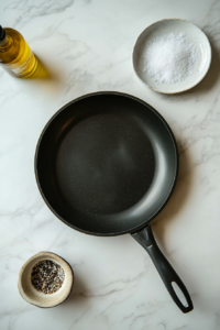 This image shows a skillet being preheated on the stove in preparation for cooking the shrimp for the Caesar salad.