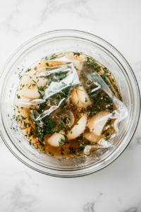 This image shows a jar of prepared pickling liquid placed in a refrigerator to cool and allow the flavors to meld together.