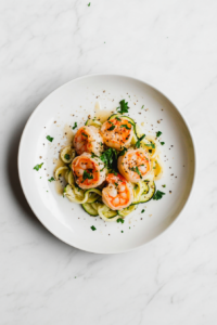 This image showcases the completed dish of garlic butter shrimp and zucchini noodles, beautifully plated and ready to serve.