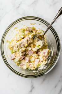 This image shows all the ingredients being mixed together in a bowl, creating a smooth and flavorful keto deviled ham salad.