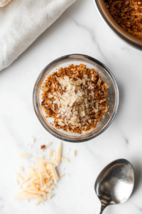 This image shows breadcrumbs being mixed with seasonings and other ingredients to form a flavorful addition to the lasagna layers.