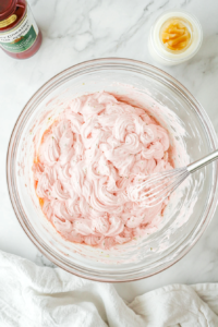 this image shows whisk blending the ingredients in the bowl, creating a smooth and creamy Thousand Island dressing.