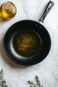 This image shows olive oil being heated in a skillet, ready for cooking the shrimp to golden perfection.