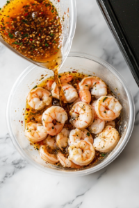 This image shows a rich marinade being poured into a Ziploc bag containing raw shrimp and scallops, preparing them for grilling.