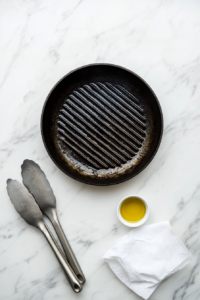 This image shows a grill being preheated, with the grates heating up in preparation for cooking keto grilled lemon shrimp skewers.