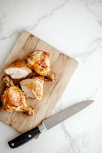 This image shows raw chicken being prepared for cooking, which will later be sliced and used as the protein base for the keto chicken taco lettuce wraps.