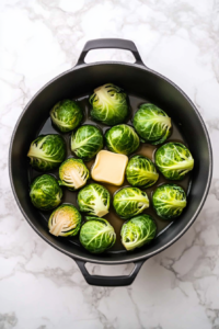 this image shows Brussels sprouts are removed from the pot, while vegan butter is melting, ready to be incorporated into the creamy sauce.