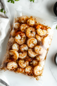 This image shows a Ziploc bag sealed and gently shaken to evenly coat shrimp and scallops with the marinade.