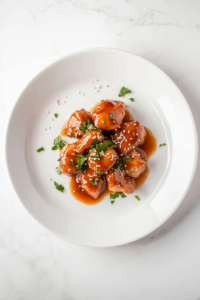 This image shows Crockpot Honey Garlic Chicken plated and garnished with fresh cilantro and sesame seeds, ready to be served as a flavorful and satisfying meal.