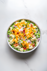 This image shows the prepared low-carb pea salad served in a white bowl, ready to be enjoyed, or stored in the refrigerator for later use.