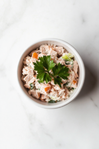 this image shows bowl of chilled tuna salad with egg, ready to be served as a refreshing dish or used as a flavorful filling for sandwiches and wraps.