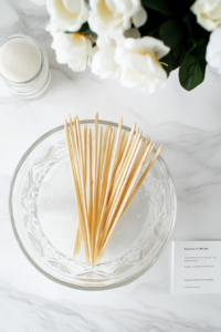 This image depicts wooden skewers soaking in a bowl of water to prevent them from burning on the grill.