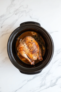 This image shows the turkey breast cooking on high heat in the slow cooker, with steam beginning to rise as it starts to cook.