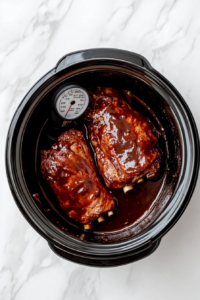 this image shows hand holding a meat thermometer checks the internal temperature of the pork tenderloin to ensure it is perfectly cooked.