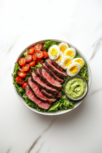 This image shows creamy avocado dressing being prepared in a blender, the perfect topping to enhance the flavors of the Steak Cobb Salad.