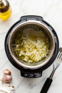 heating-the-olive-oil-and-onion-in-the-pot-to-saute-them-slightly-before-adding-vegetables