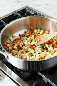 adding-minced-garlic-salt-and-black-pepper-to-sauteed-vegetables-for-flavor