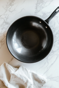 This image shows a clean wok, ready to be used for preparing the rich and tangy orange sauce.