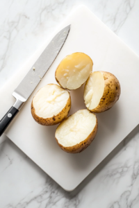 This image shows baked potatoes being sliced in half, preparing them for the delicious filling.