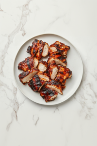 This image shows freshly cooked Qdoba-style chicken resting on a cutting board, allowing the juices to redistribute before slicing.