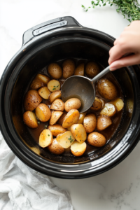 This image shows drained cooked potatoes being prepared for mashing, removing excess liquid for a creamy consistency.